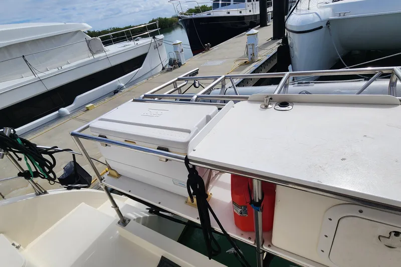 Slide: The Image of 2005 Endeavour 44 TrawlerCat docked, featuring deck equipment and storage. - 58