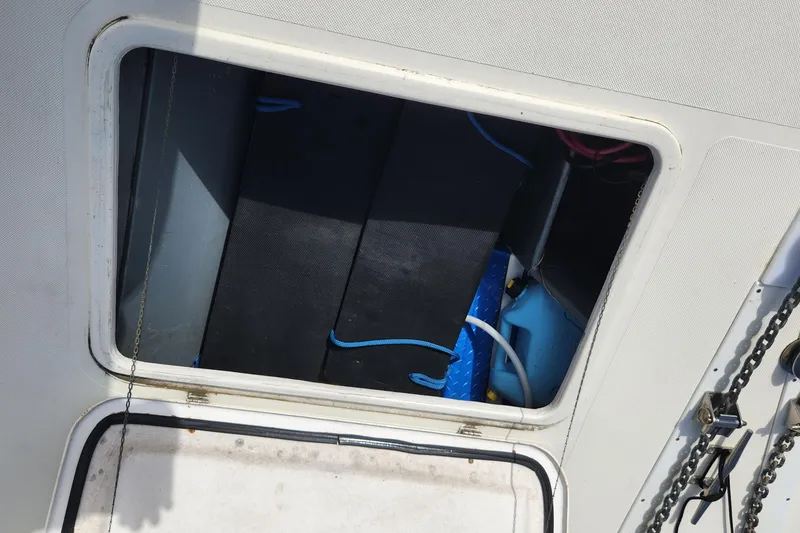 Slide: The Image of Open hatch on 2005 Endeavour 44 TrawlerCat, revealing storage compartment with equipment. - 65