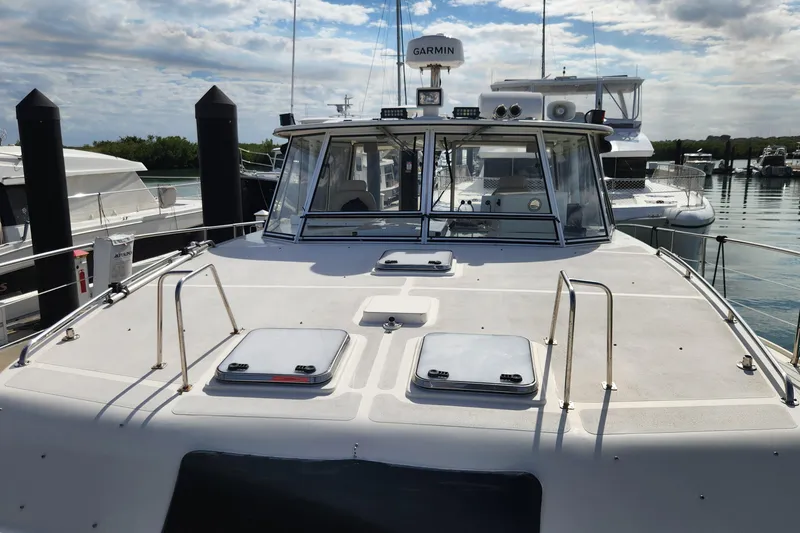 Slide: The Image of 2005 Endeavour 44 TrawlerCat docked at marina under cloudy sky. - 66