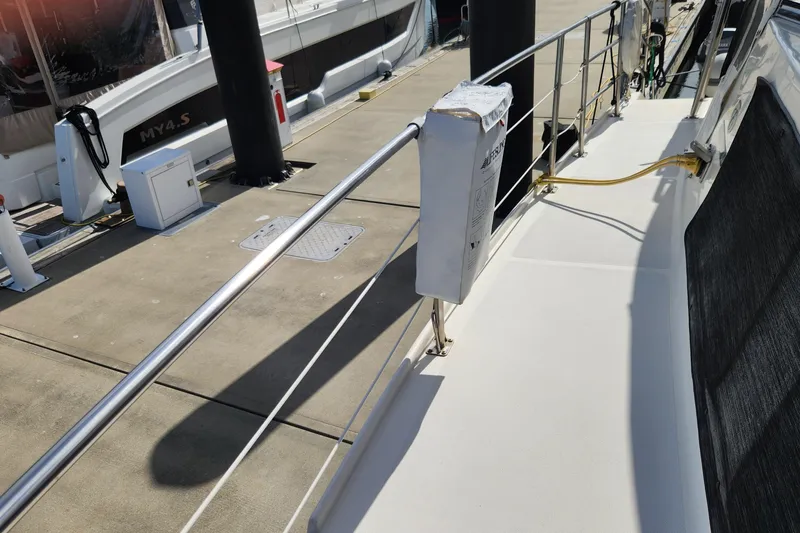 Slide: The Image of 2005 Endeavour 44 TrawlerCat docked, showing deck and railing details. - 69