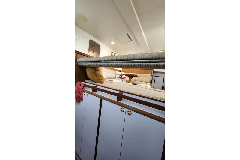 Slide: The Image of Interior of 2005 Endeavour 44 TrawlerCat, featuring cozy seating and storage cabinets. - 7