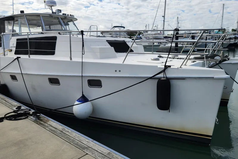 Slide: The Image of 2005 Endeavour 44 TrawlerCat docked at marina under cloudy sky. - 73