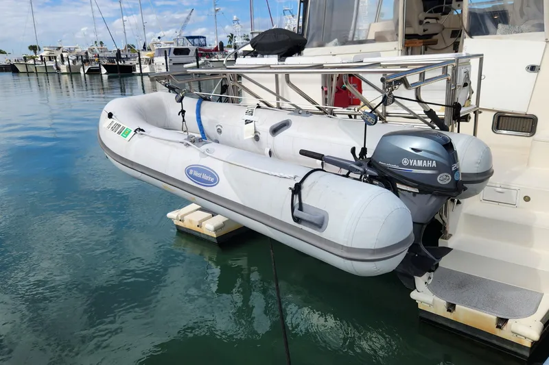 Slide: The Image of Inflatable dinghy with Yamaha motor on 2005 Endeavour 44 TrawlerCat, docked in marina. - 75