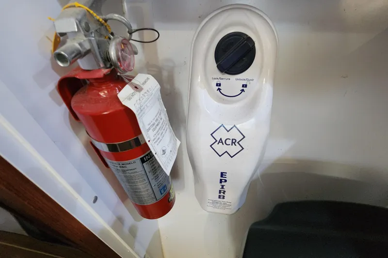 Slide: The Image of Fire extinguisher and EPIRB on 2005 Endeavour 44 TrawlerCat boat. - 77