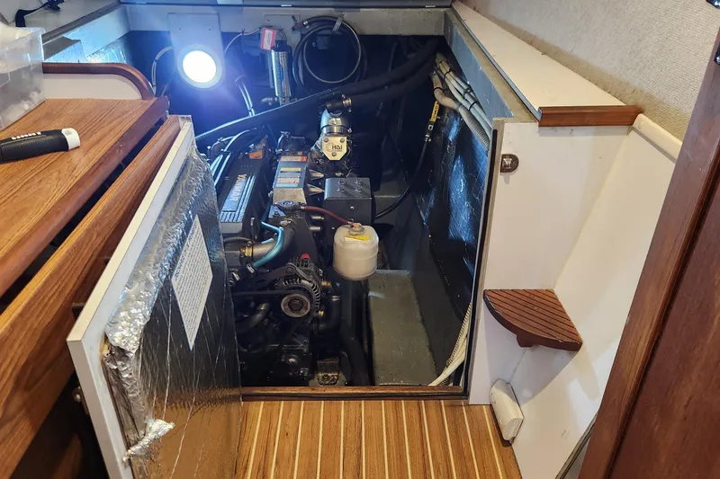 Slide: The Image of Engine room of 2005 Endeavour 44 TrawlerCat with visible machinery and wooden flooring. - 79