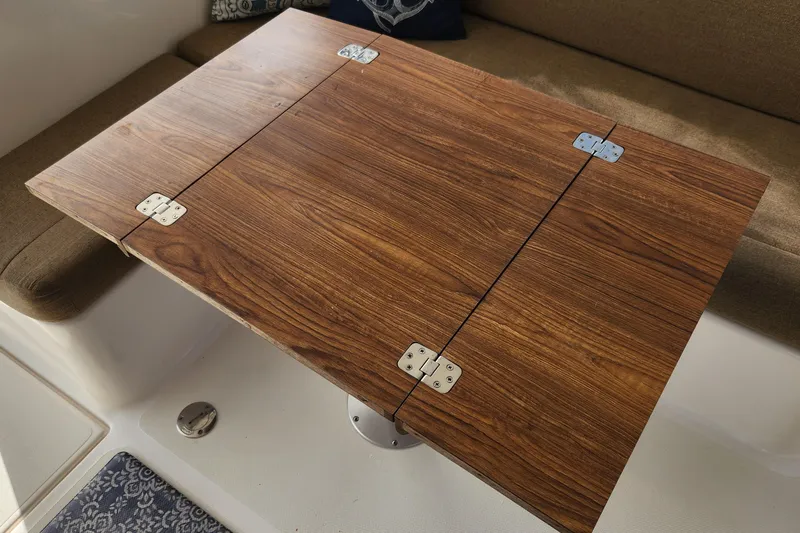 Slide: The Image of Wooden table with metal hinges on Endeavour 44 TrawlerCat, 2005 model. - 80