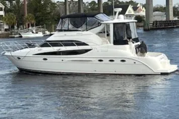 Slide: The Image of 2004 Meridian 459 Motoryacht cruising on a calm river with scenic background. - 10