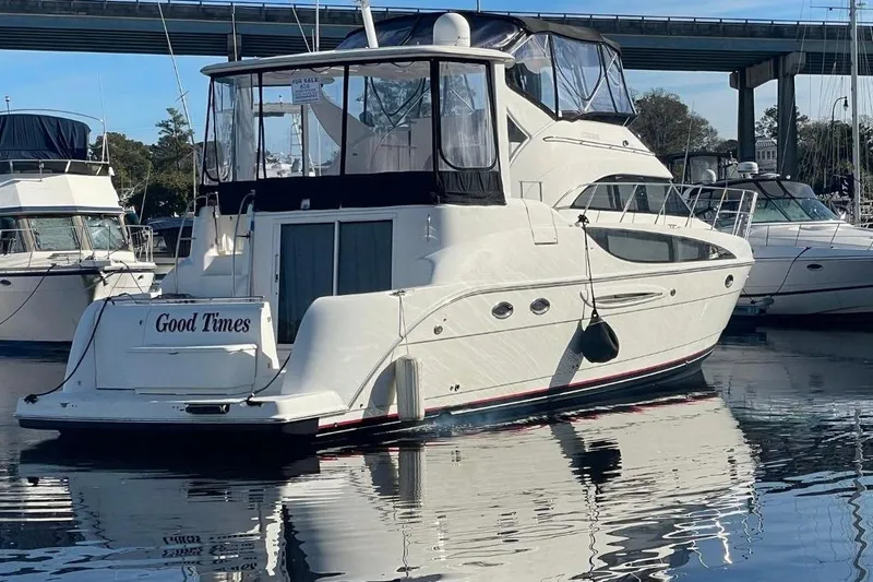 Slide: The Image of 2004 Meridian 459 Motoryacht named "Good Times" docked in marina. - 2