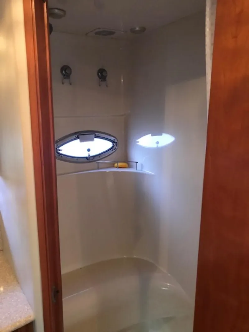 Slide: The Image of 2004 Meridian 459 Motoryacht shower with oval window and modern fixtures. - 40