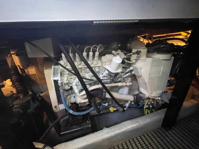 Slide: The Image of Engine compartment of a 2004 Meridian 459 Motoryacht, showcasing mechanical components and wiring. - 47