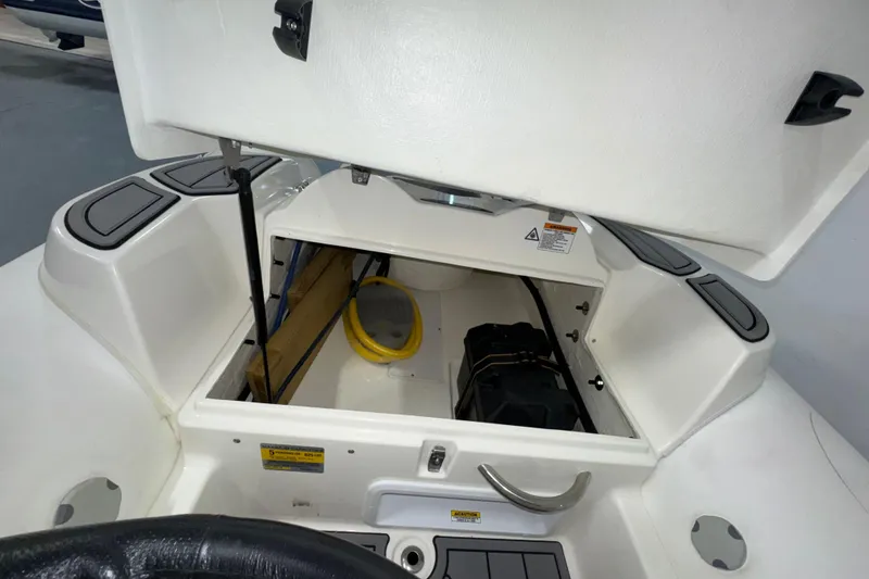 Slide: The Image of Open storage compartment on 2026 Zodiac Yachtline 400 boat, featuring interior equipment. - 5