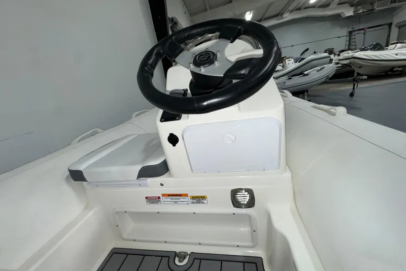 Slide: The Image of 2026 Zodiac Yachtline 400 steering console in a showroom setting. - 6