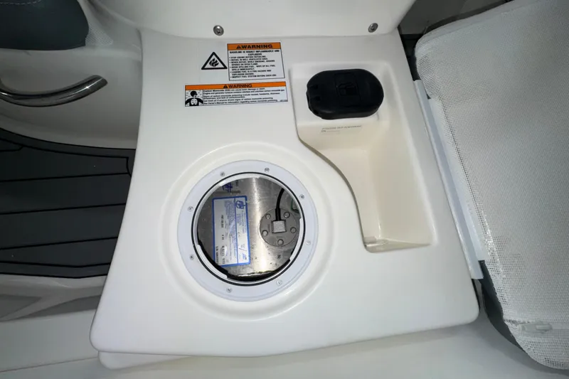 Slide: The Image of Control panel of 2026 Zodiac Yachtline 400 with warning labels and seating area. - 8