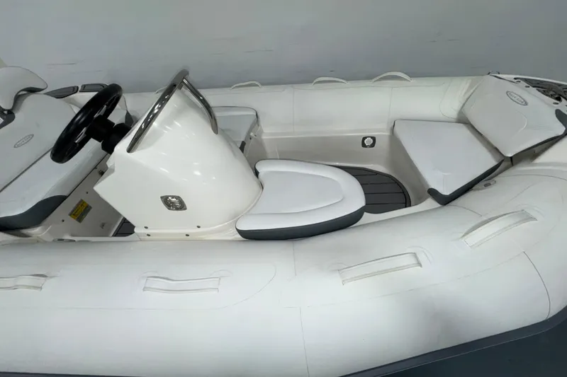 Slide: The Image of 2026 Zodiac Yachtline 400 inflatable boat interior with steering console and seating. - 9