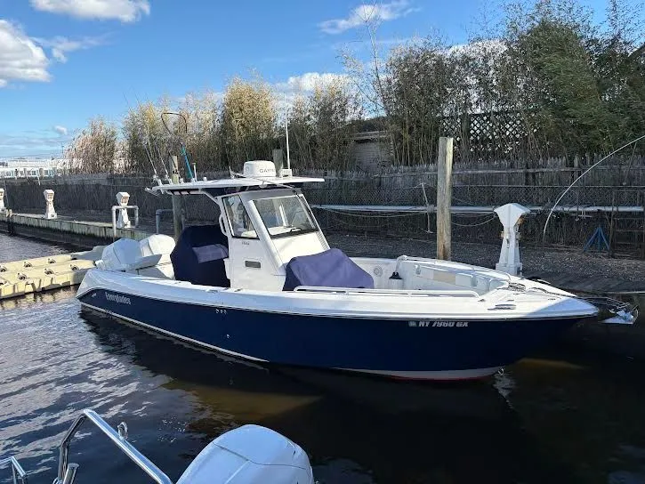 The Image of 2016 Everglades 295 Center Console boat in water, blue hull. - 0