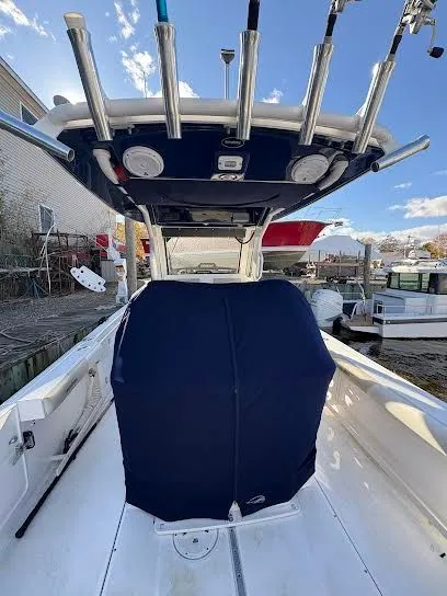 Slide: The Image of 2016 Everglades 295 Center Console boat with cover and fishing rod holders. - 7