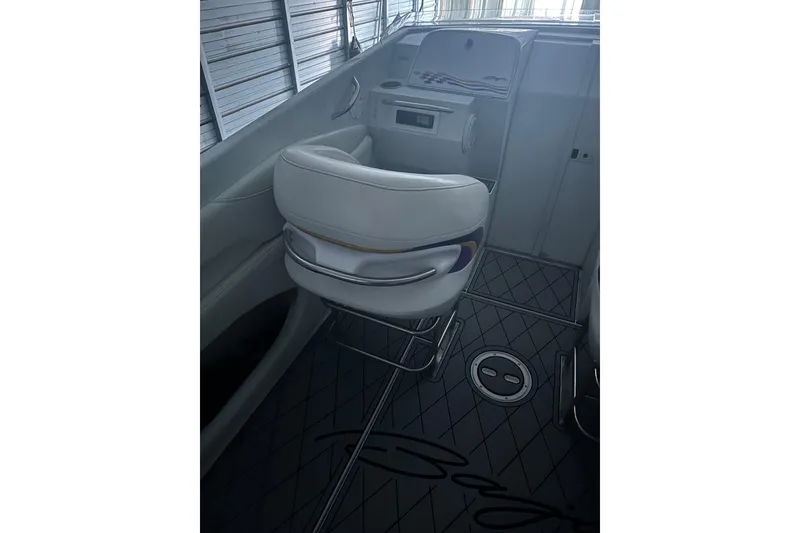 Slide: The Image of Interior of a 1999 Baja 33 Outlaw boat with white seating and sleek design. - 13