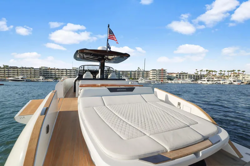 Slide: The Image of 2022 Solaris Power yacht with sunbed, marina view, and American flag. - 6