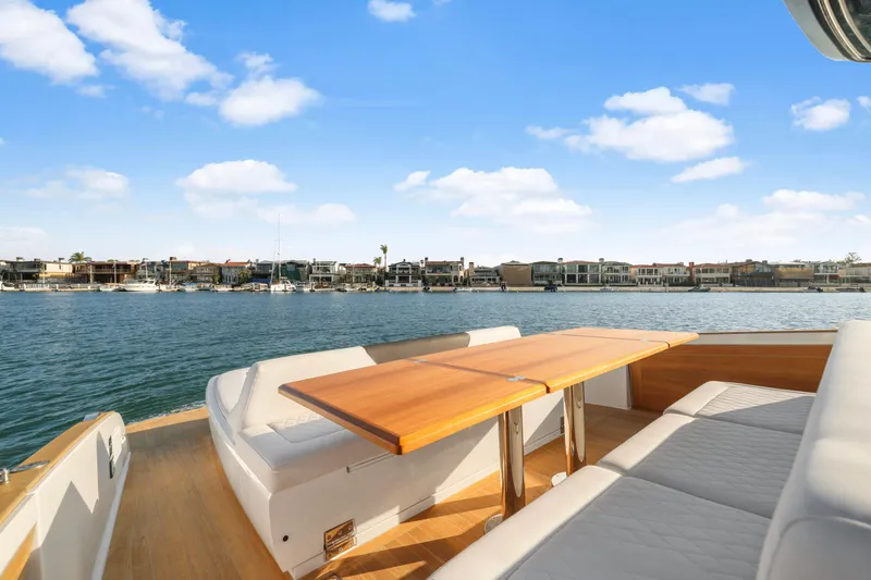 Slide: The Image of Luxurious 2022 Solaris Power yacht with spacious deck and scenic waterfront view. - 7