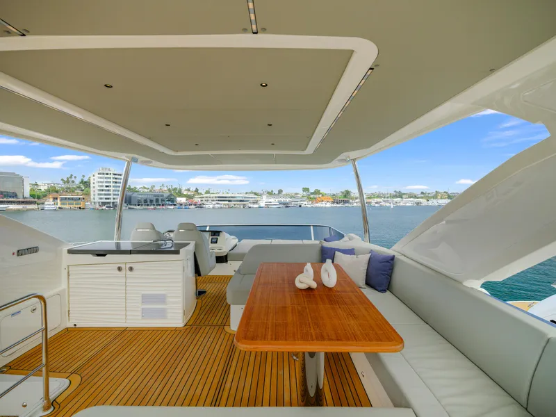 Slide: The Image of Luxurious 2024 Absolute 60 Fly yacht interior with elegant seating and scenic waterfront view. - 11