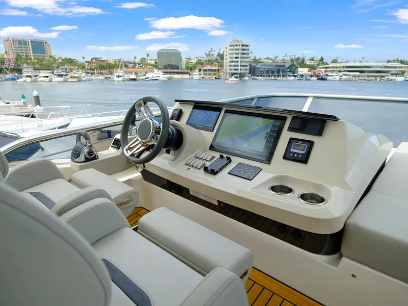 Slide: The Image of Luxurious helm of 2024 Absolute 60 Fly Co Ownership yacht with marina view. - 16
