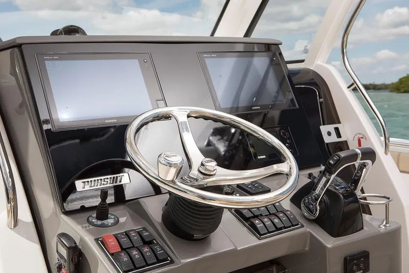 Slide: The Image of Manufacturer Provided Image: 2021 Pursuit S 328 Sport boat dashboard with dual screens and steering wheel. - 12