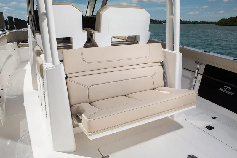 Slide: The Image of Manufacturer Provided Image: 2021 Pursuit S 328 Sport boat with beige seating and ocean backdrop. - 16