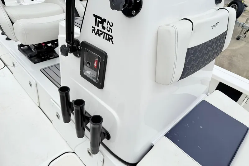 Slide: The Image of 2023 Tidewater 25 TPC Raptor boat interior with rod holders and cushioned seating. - 13