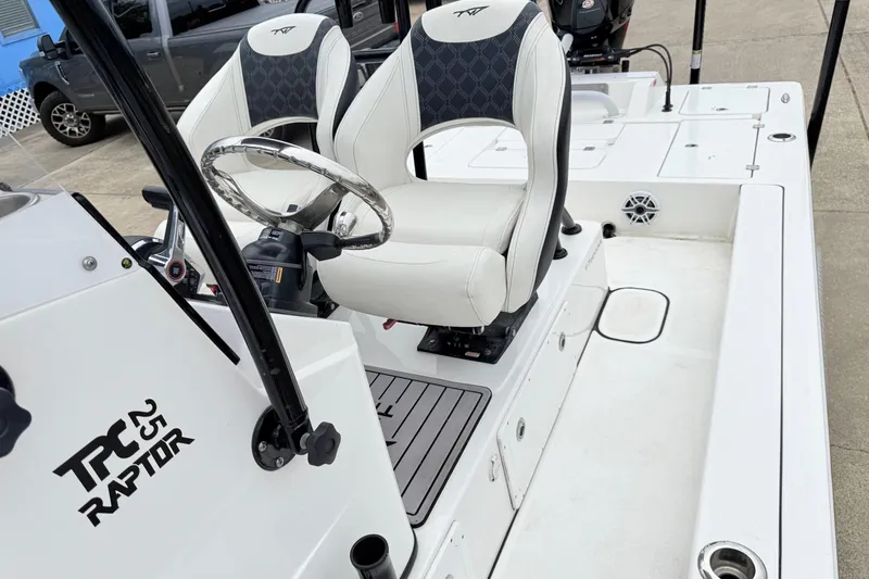 Slide: The Image of 2023 Tidewater 25 TPC Raptor boat interior with steering wheel and seating. - 14