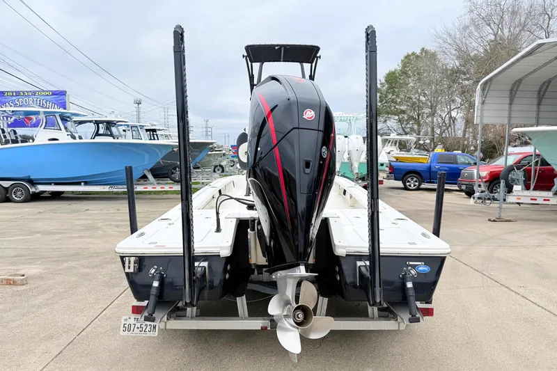Slide: The Image of 2023 Tidewater 25 TPC Raptor boat with powerful outboard motor, parked on a trailer. - 3