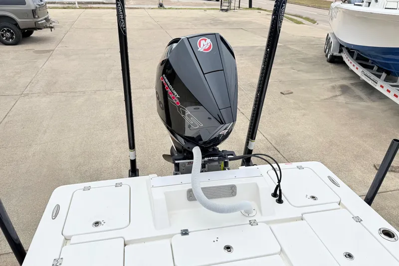 Slide: The Image of 2023 Tidewater 25 TPC Raptor boat with powerful outboard motor in a parking area. - 6