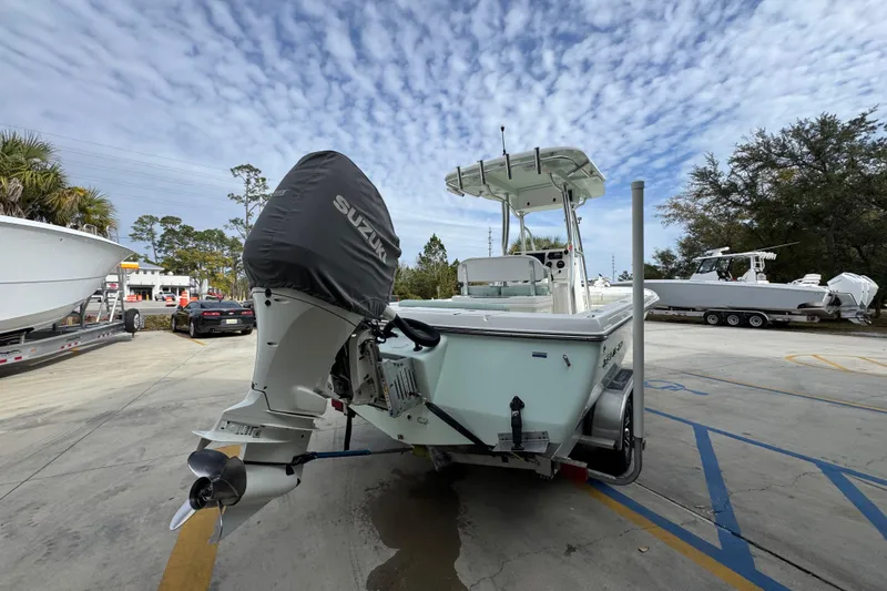 Slide: The Image of 2017 Sea Born FX25 Bay boat with Suzuki outboard motor in a parking lot. - 12