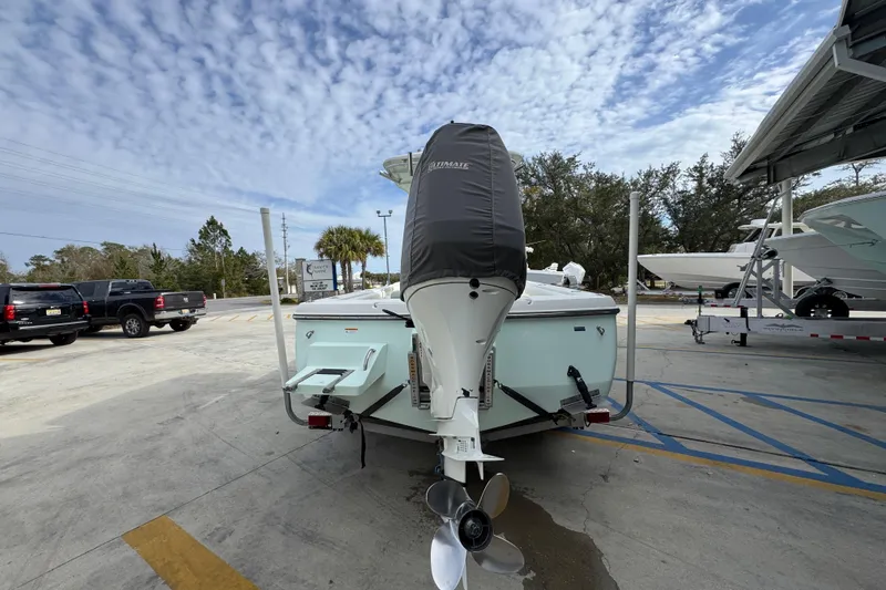 Slide: The Image of 2017 Sea Born FX25 Bay boat with covered outboard motor in a parking lot. - 13