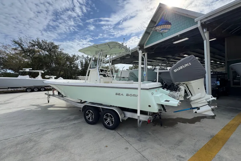 Slide: The Image of 2017 Sea Born FX25 Bay boat on trailer with Suzuki outboard motor. - 16