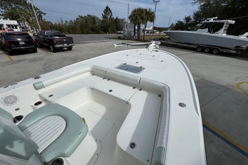 Slide: The Image of 2017 Sea Born FX25 Bay boat with spacious deck and seating, parked outdoors. - 17