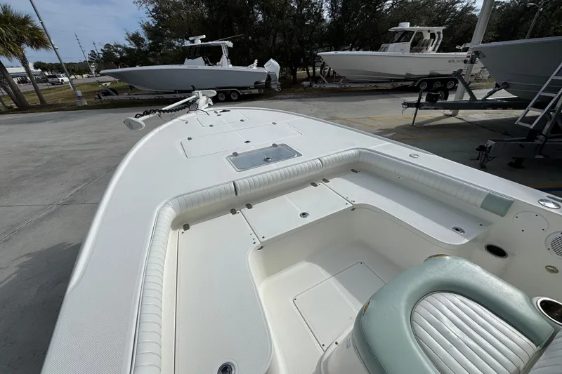 Slide: The Image of 2017 Sea Born FX25 Bay boat with spacious deck and seating, parked outdoors. - 19