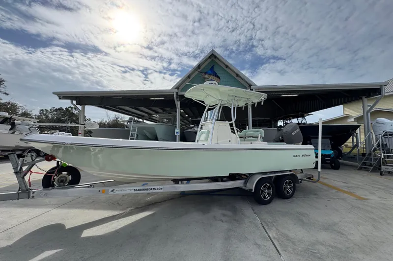 Slide: The Image of 2017 Sea Born FX25 Bay boat on trailer under cloudy sky. - 2