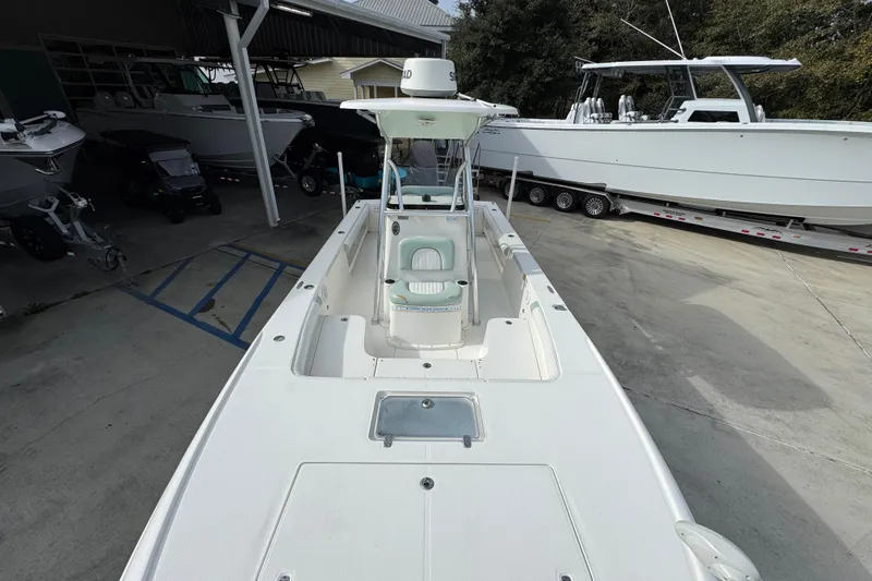 Slide: The Image of 2017 Sea Born FX25 Bay boat in a marina, surrounded by other vessels. - 23