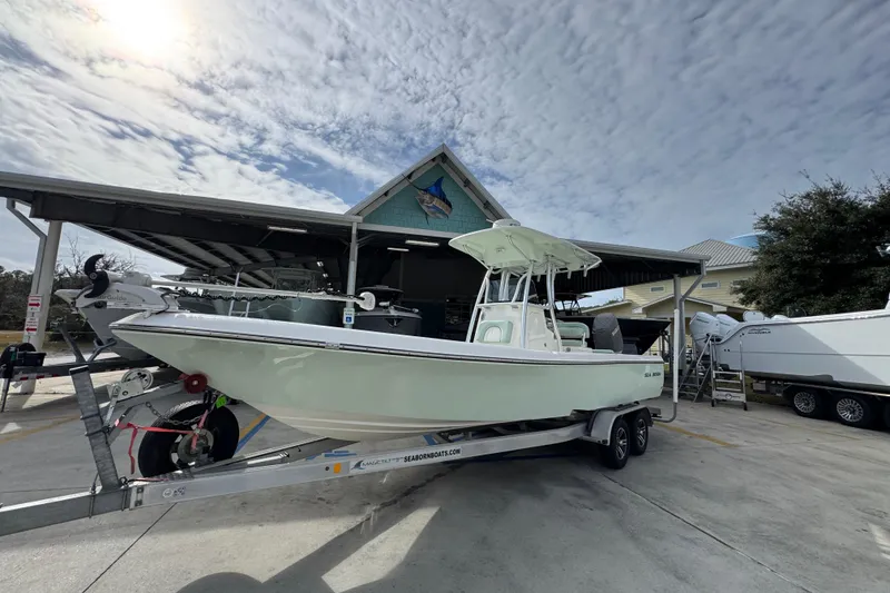 Slide: The Image of 2017 Sea Born FX25 Bay boat on trailer under cloudy sky. - 3