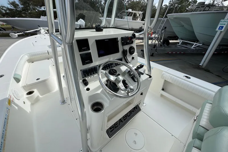 Slide: The Image of 2017 Sea Born FX25 Bay boat interior with steering console and seating. - 31