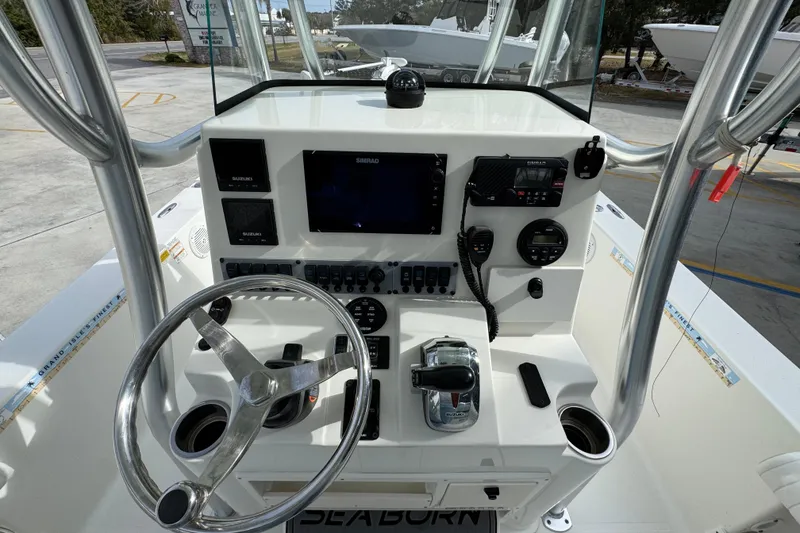 Slide: The Image of 2017 Sea Born FX25 Bay boat console with steering wheel and navigation controls. - 32