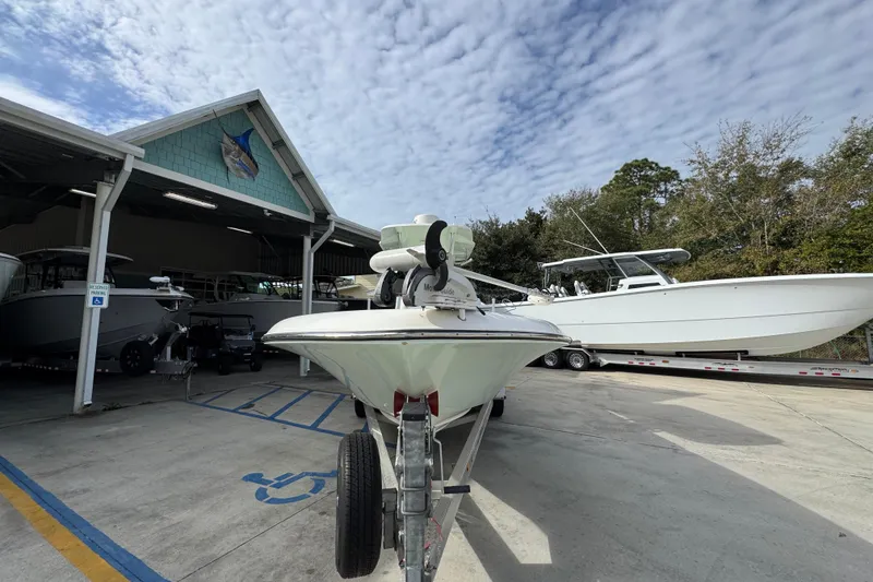 Slide: The Image of 2017 Sea Born FX25 Bay boat on trailer at marina under cloudy sky. - 5