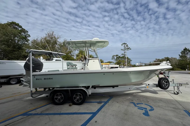 Slide: The Image of 2017 Sea Born FX25 Bay boat on trailer, parked outdoors under cloudy sky. - 9