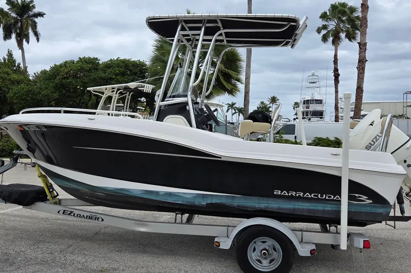 The Image of 2017 Barracuda 188 CCF boat on trailer, parked outdoors with palm trees in background. - 1
