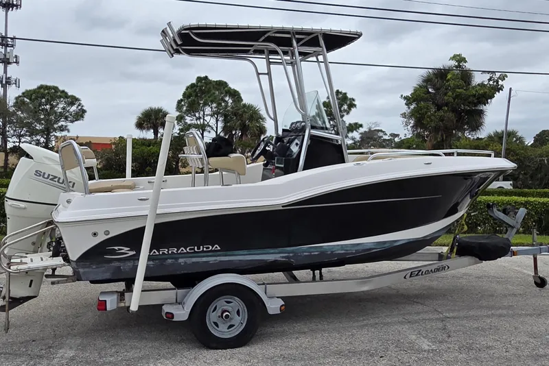 Slide: The Image of 2017 Barracuda 188 CCF boat on trailer with Suzuki engine, parked outdoors. - 3