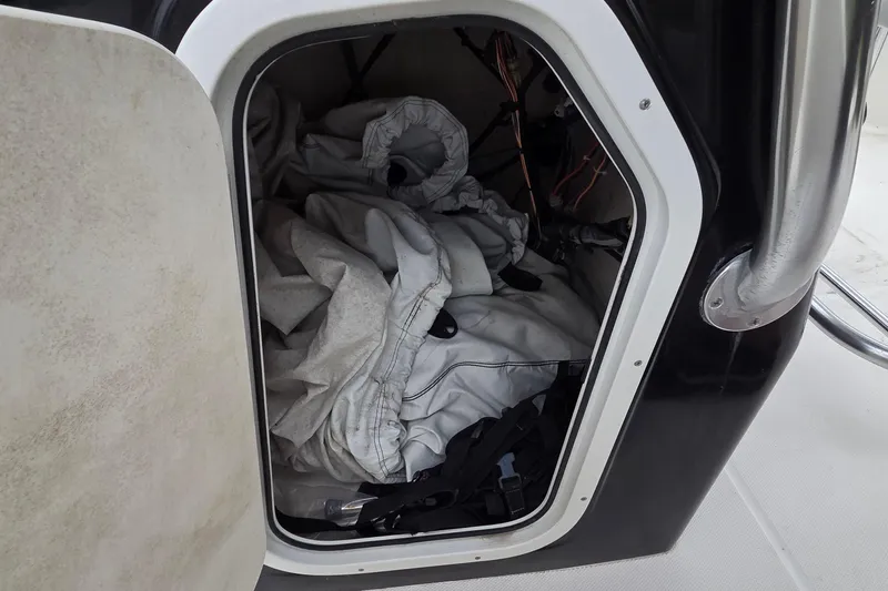 Slide: The Image of Storage compartment on a 2017 Barracuda 188 CCF boat with gear inside. - 8