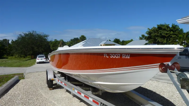 Slide: The Image of 1971 Magnum Sport boat on trailer, red and white hull, registration FL 3007 RW. - 1