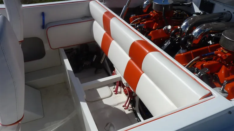 Slide: The Image of 1971 Magnum Sport boat interior with white and orange seats and visible engine. - 12
