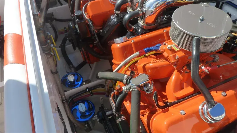 Slide: The Image of 1971 Magnum Sport engine compartment with vibrant orange components and chrome accents. - 14