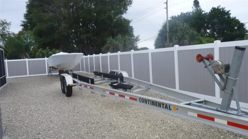 Slide: The Image of 1971 Magnum Sport boat on Continental trailer in fenced yard. - 17